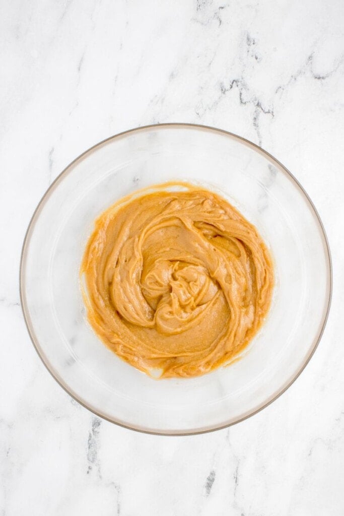 mixing wet ingredients to make peanut butter cookie dough