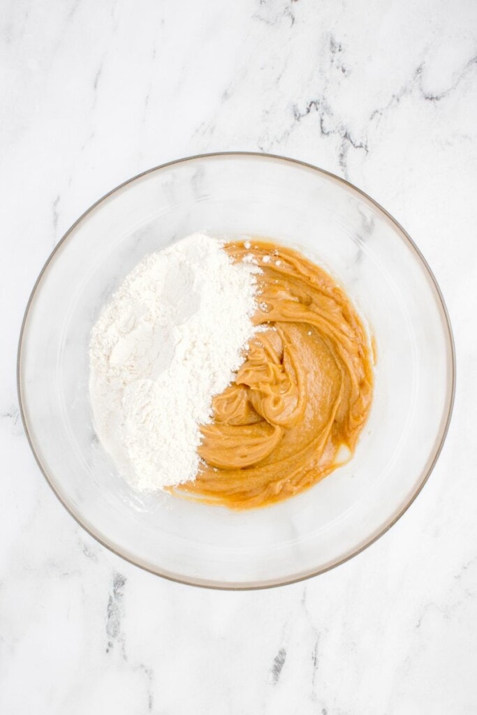 mixing flour into peanut butter and egg mixture