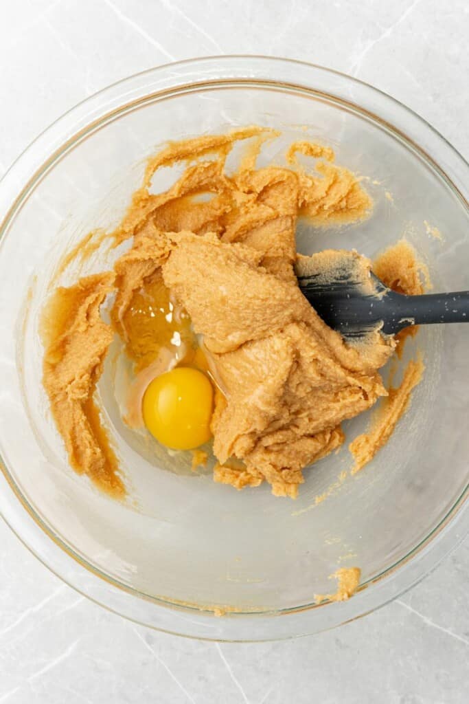 mixing together peanut butter, eggs and sugar