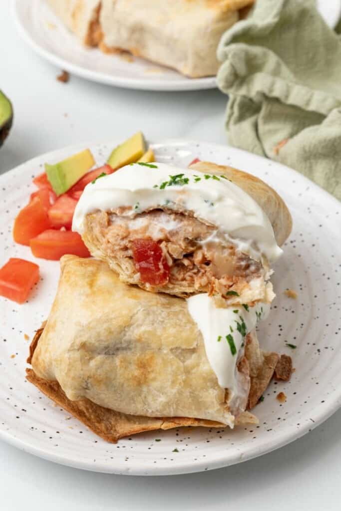 Chicken filled chimichanga cut in half.