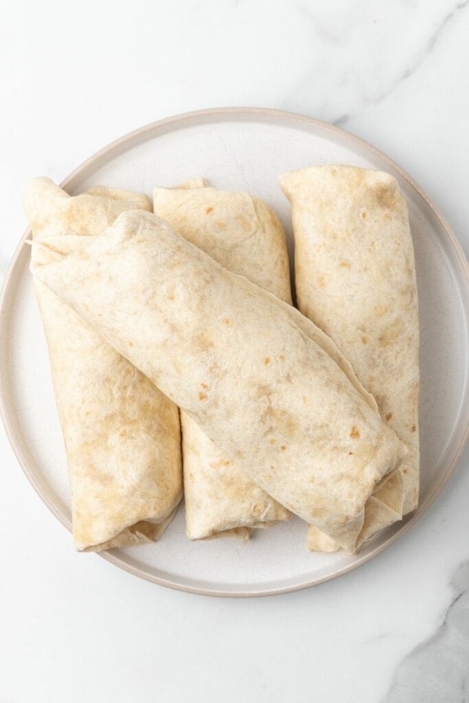 Air fryer chicken chimichangas on a plate.