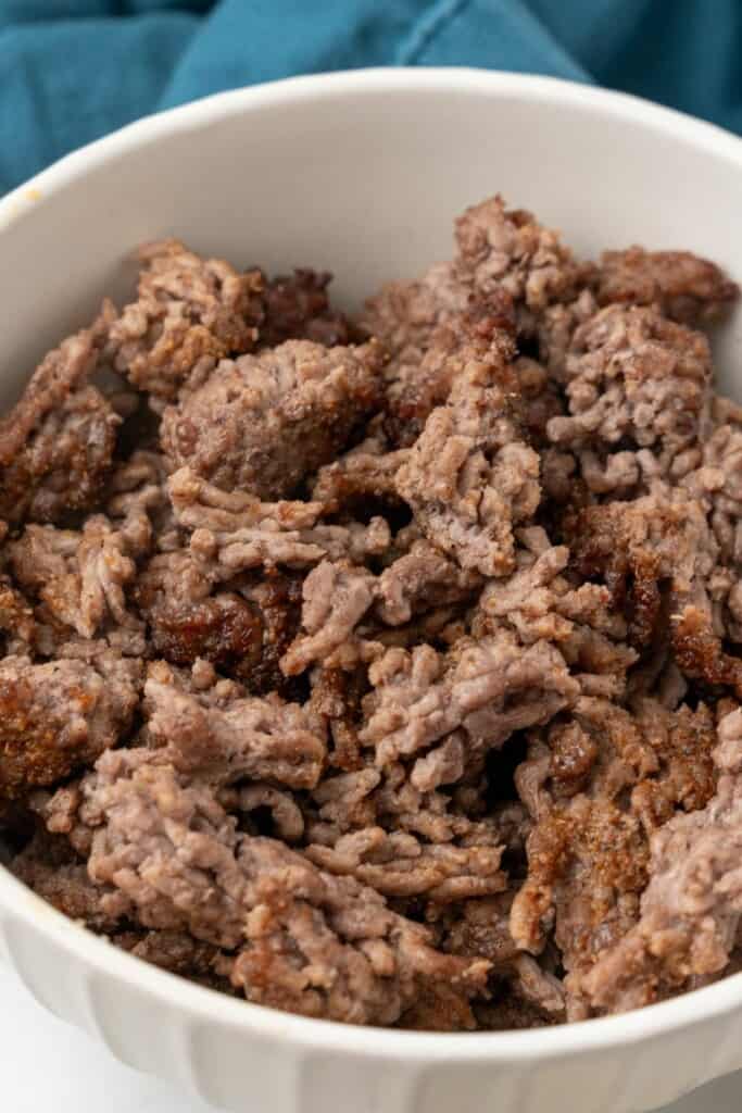 Air fryer ground beef in a white bowl.
