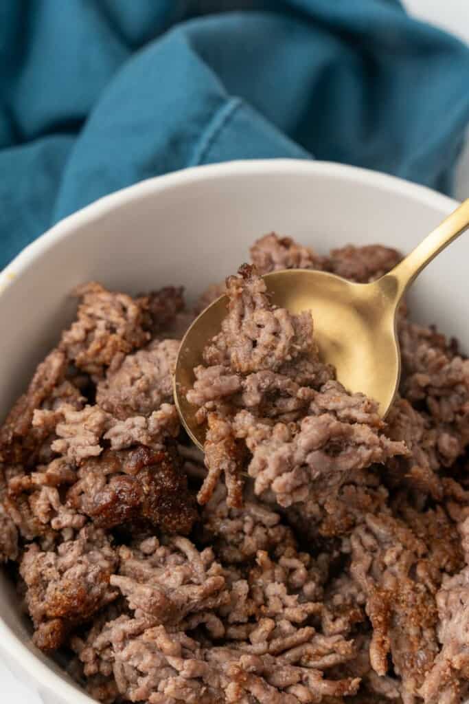 Spoonful of browned ground beef for recipes.