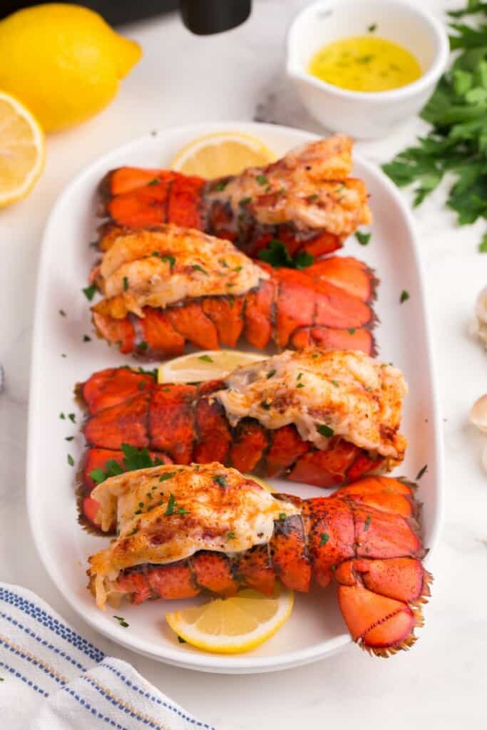 Perfectly cooked lobster tails on a plate.