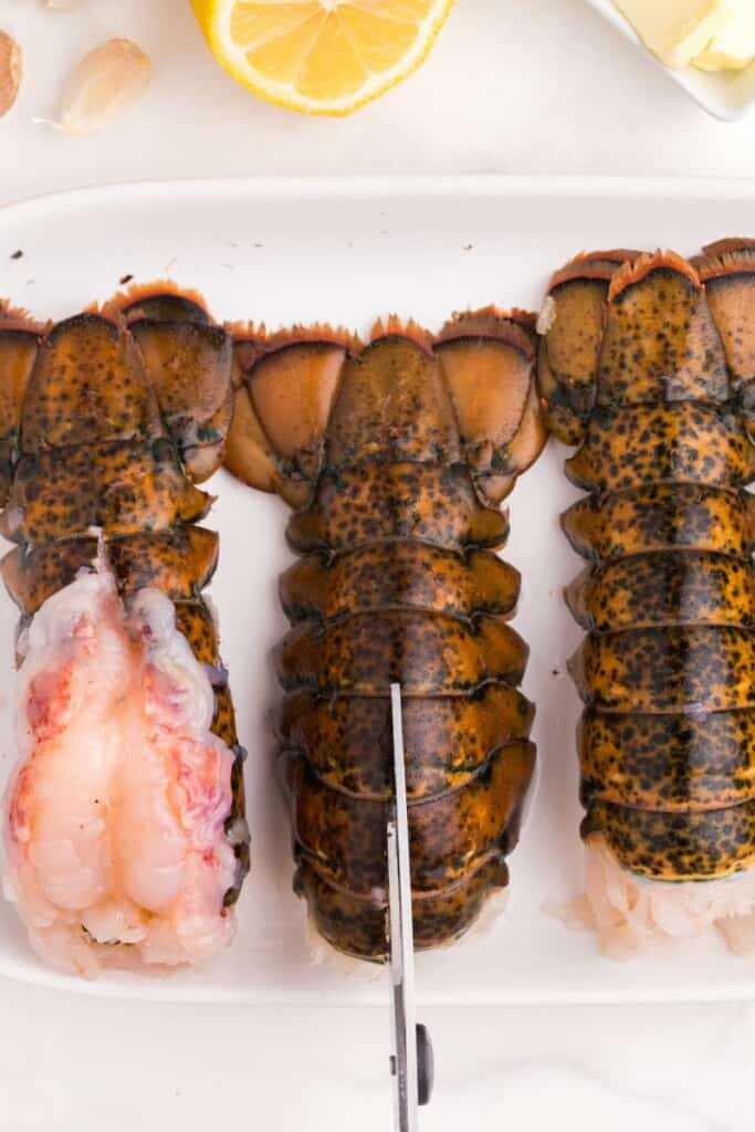 Using kitchen shears to cut open to butterfly the meat.