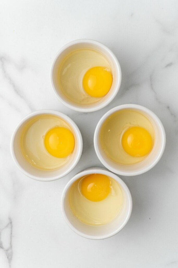 Eggs separated into small ramekins.