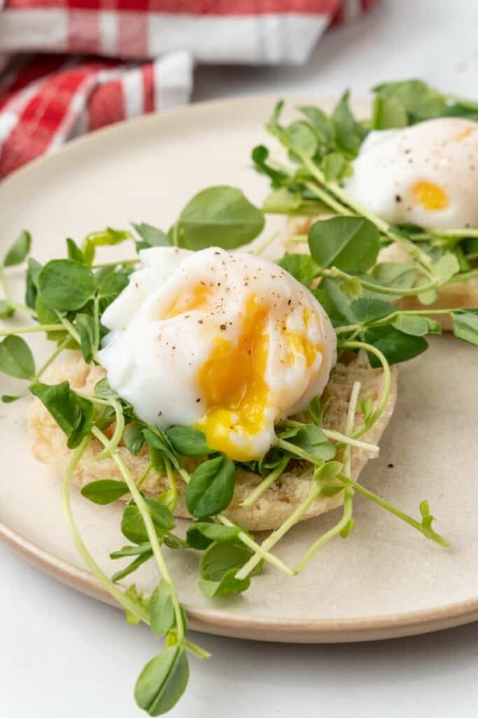 Perfectly poached egg over microgreens