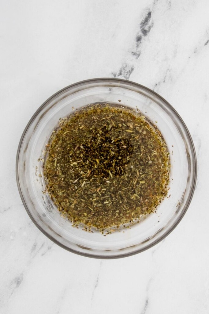 Seasonings mixed with oil in a small bowl.