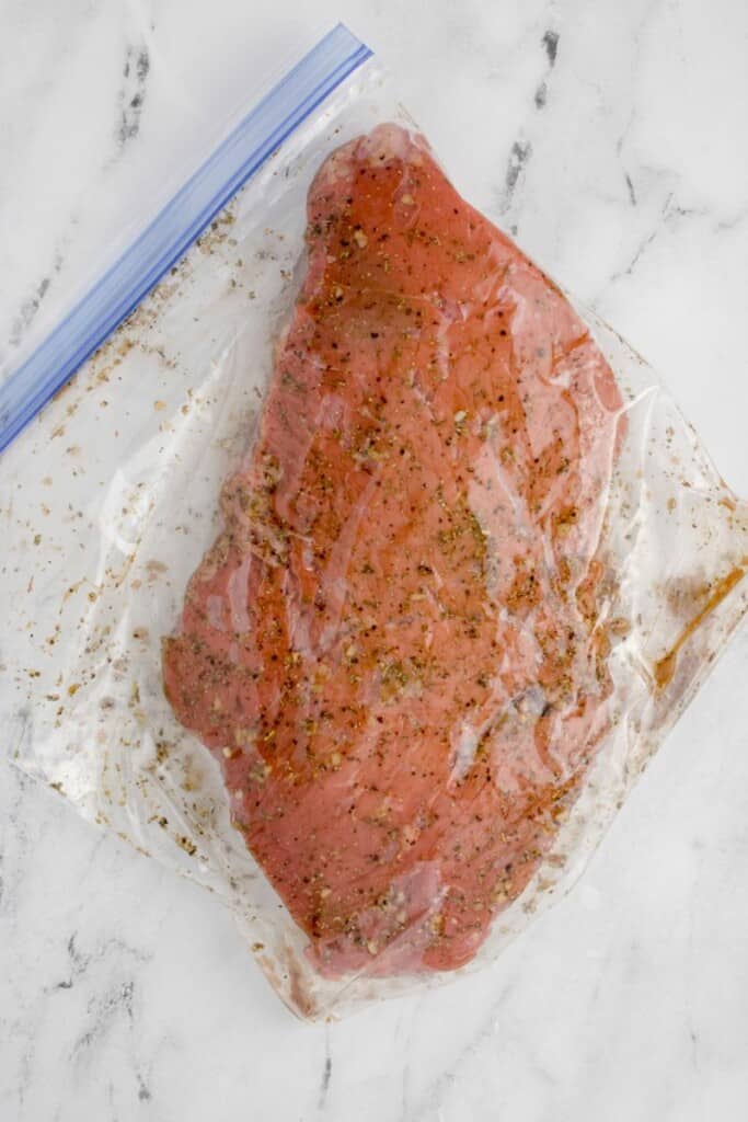 Marinated meat in a food storage bag.