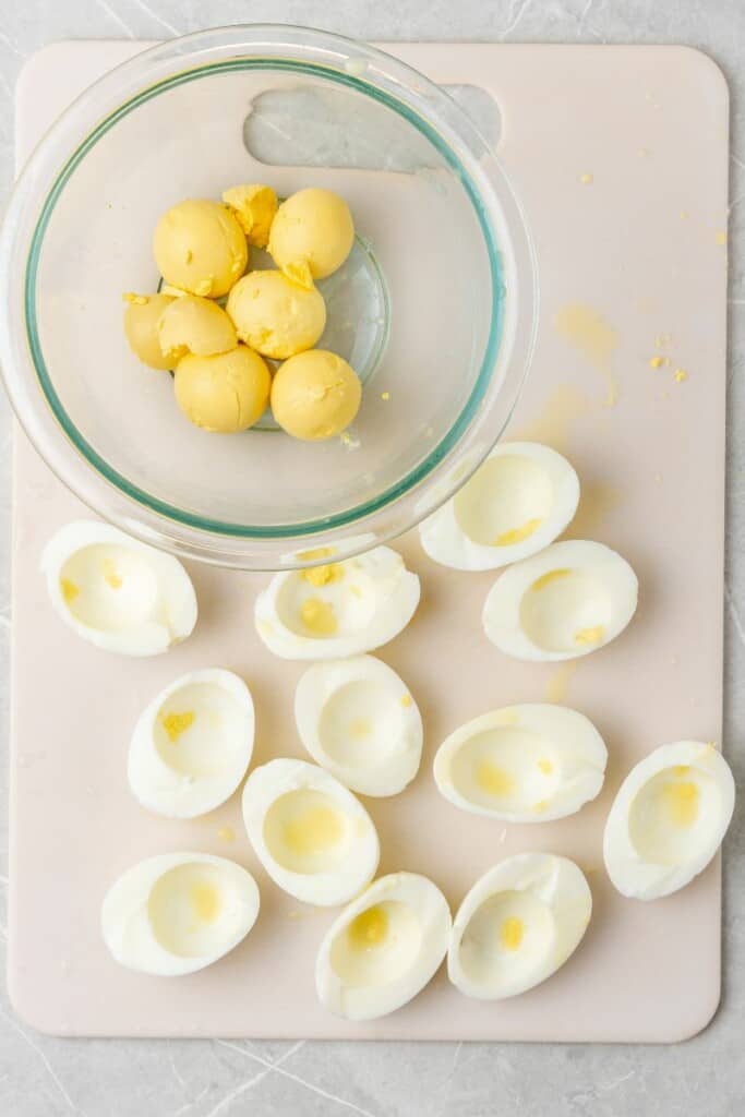 slicing hard boiled eggs and removing yolk. 