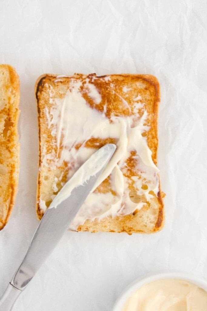 Adding mayo to toasted ciabatta.