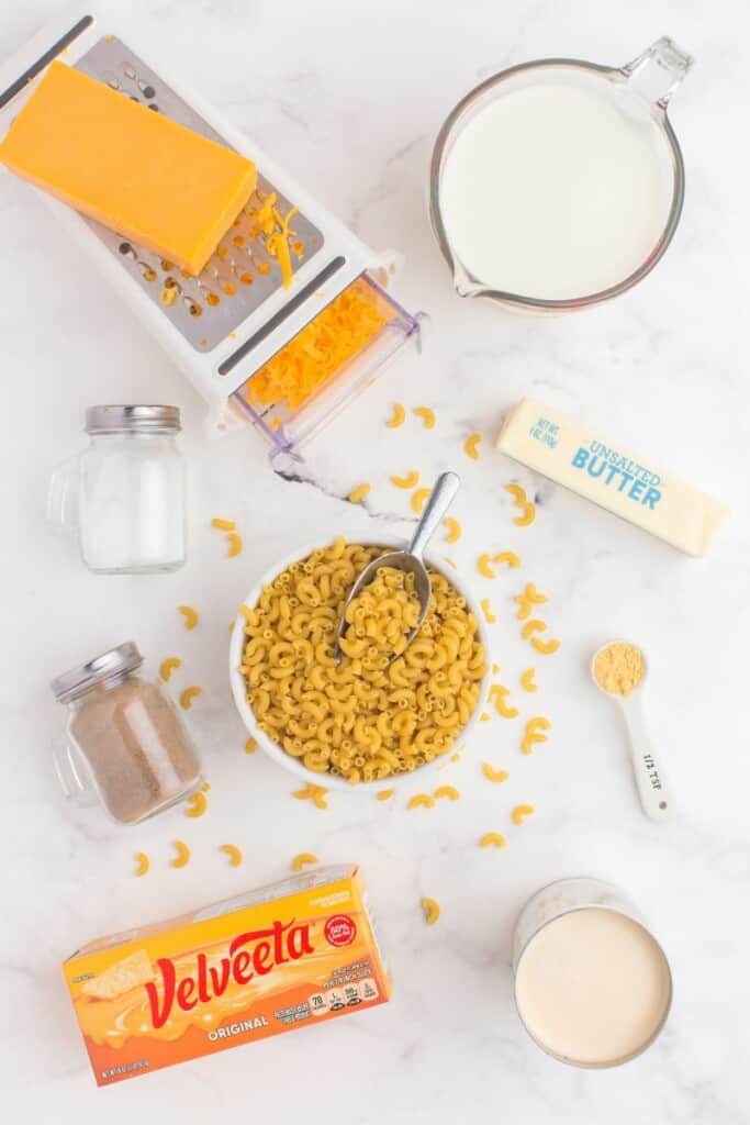 Mac and cheese ingredients on a white counter.