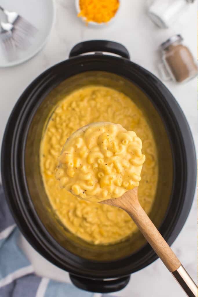 Velveeta mac and cheese scooped up on a woodn spoon.