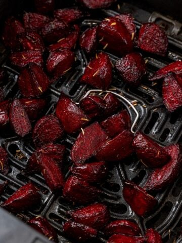 Close up of beets in an air fryer basket.