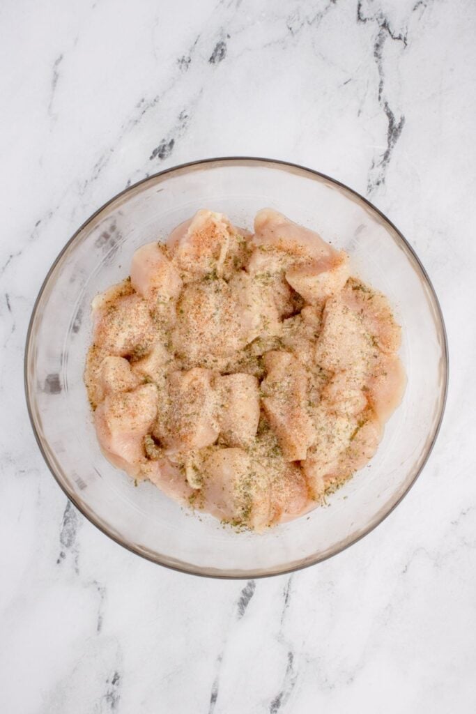 Seasoned air fry chicken bites ready to go in the air fryer.