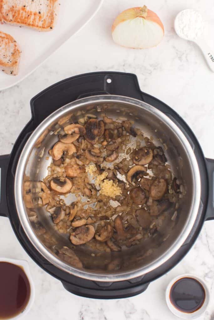 Sautéing the mushrooms and onions in the Instant Pot.