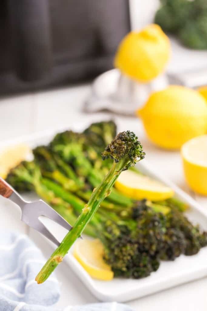 a floret of air fried broccolini on a fork