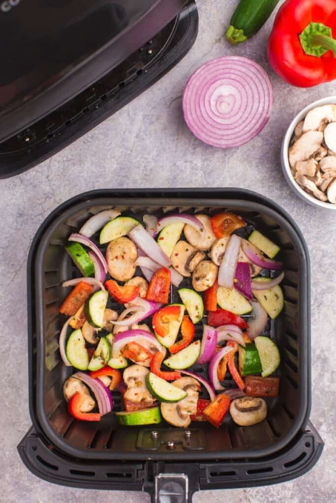 chopped veggies in air fryer basket