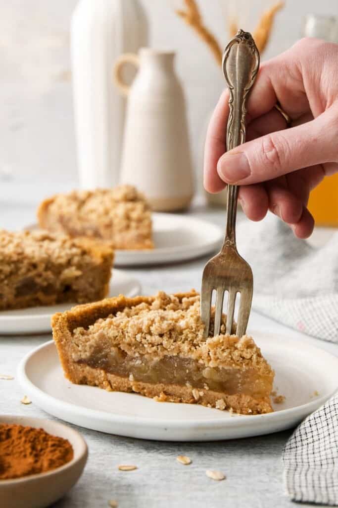 taking a bite of apple pie with graham cracker crust