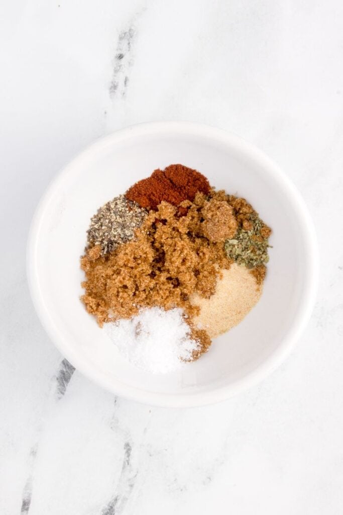 adding spices to a white bowl