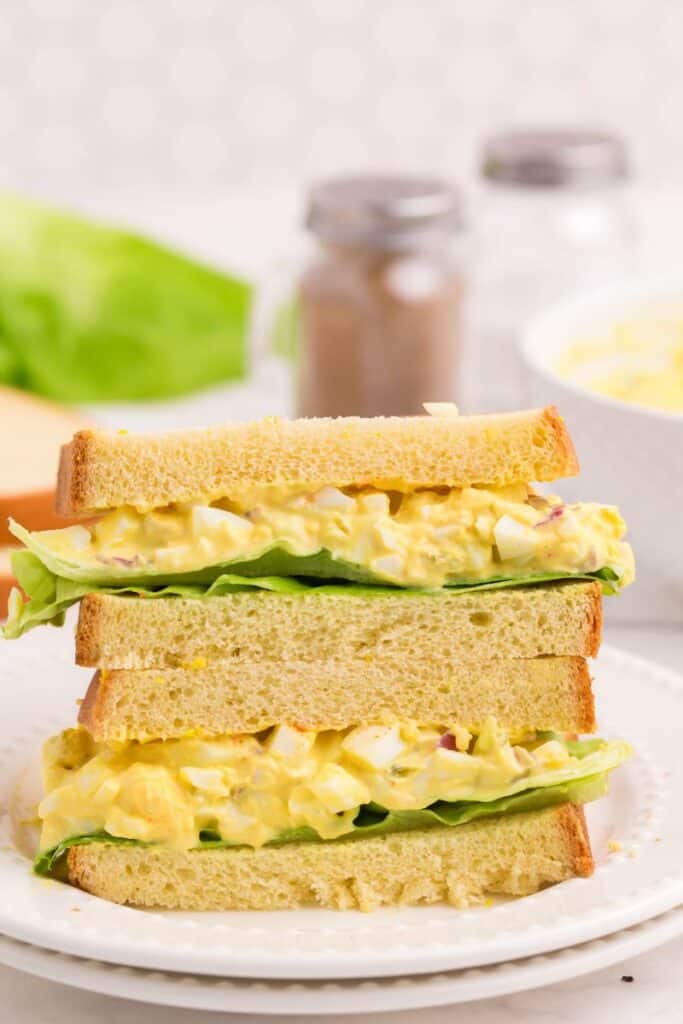 egg salad sandwich on white bread with lettuce