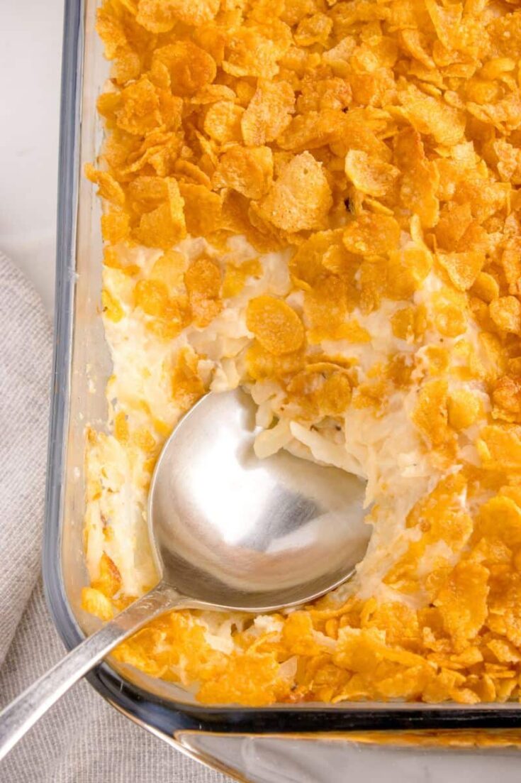scooping up some cornflake casserole with a big spoon