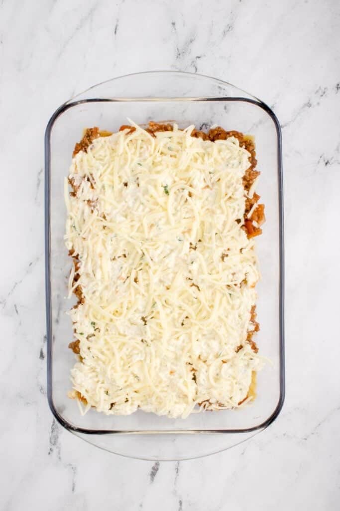topping lasagna noodles with ricotta mixture