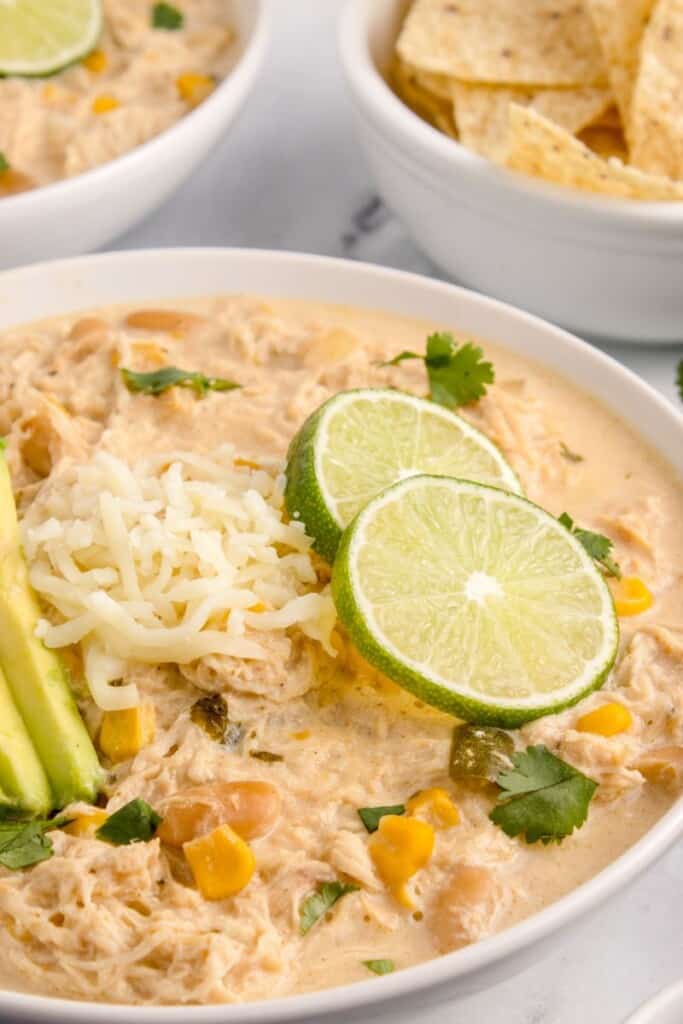 lime garnish on chicken chili in a bowl 