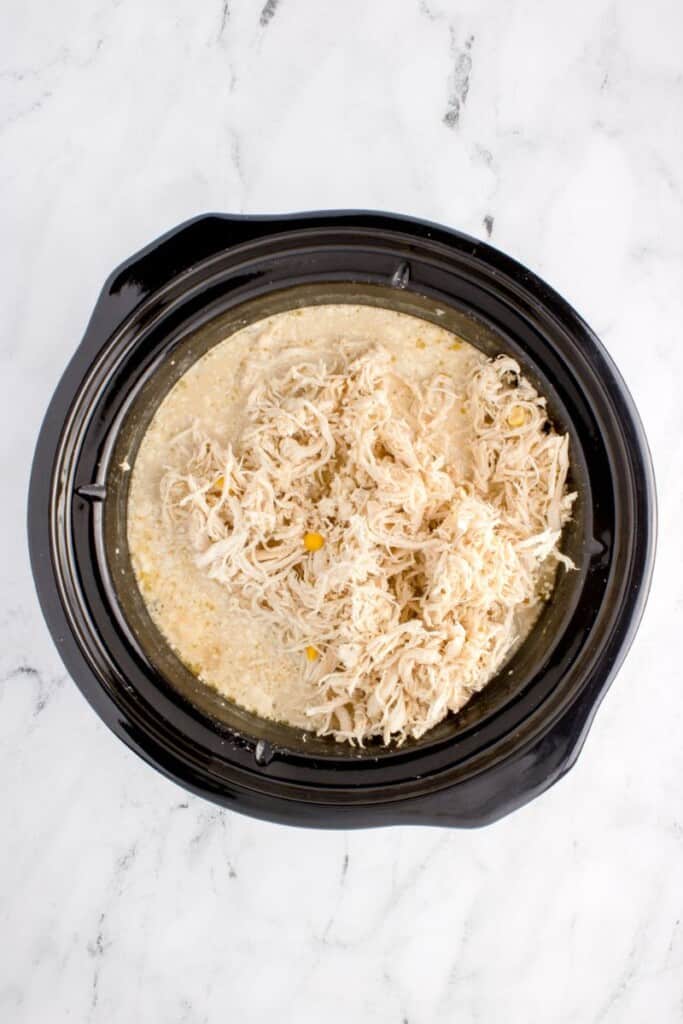 adding shedded chicken into slow cooker