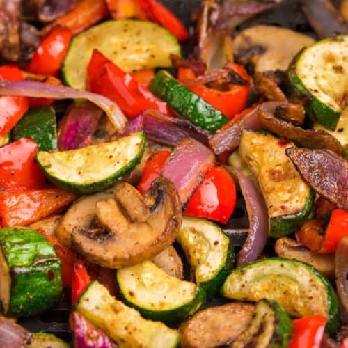 Air fryer vegetables in an air fryer basket.
