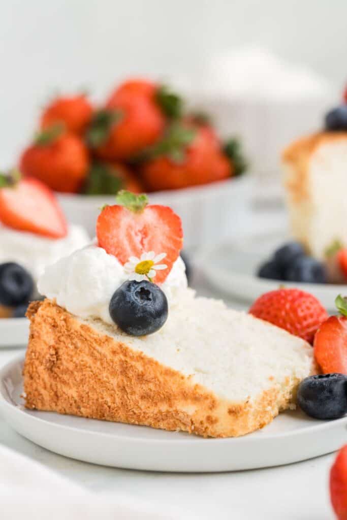 a slice of angel food cake on a plate with berries