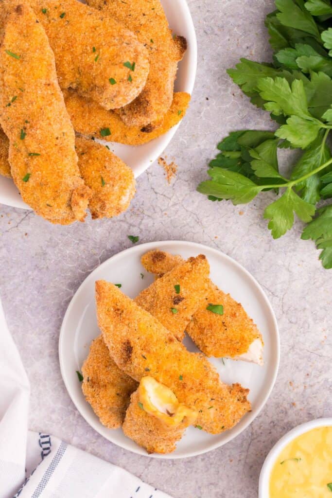 chicken tenders on a white plate.