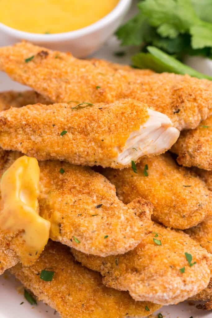 close up of breaded chicken tenders to see the inside of a piece.
