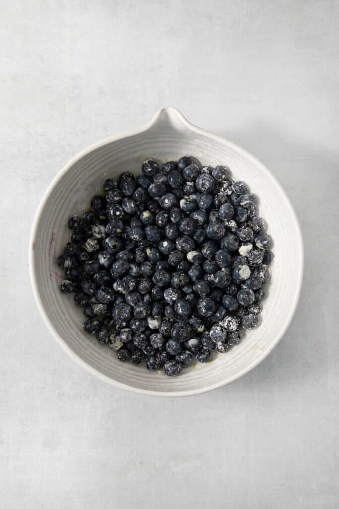 mixing blueberries with sugar and lemon zest