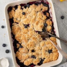 overhead shot of blueberry cobbler in a baked dish