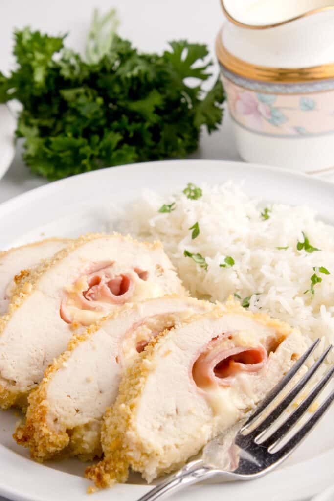 stuffed chicken with cheese and ham served with white rice 