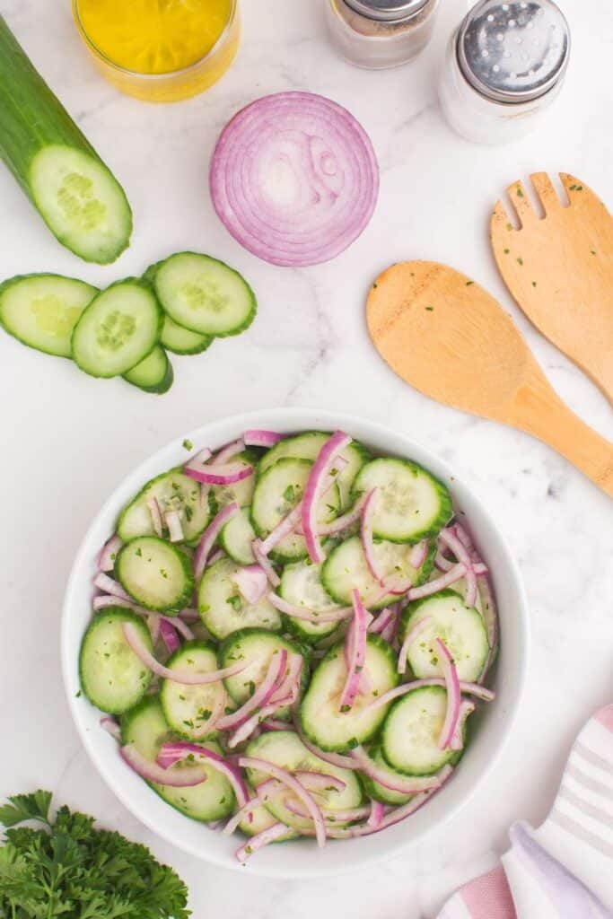 cucumber and onions with a white bowl 