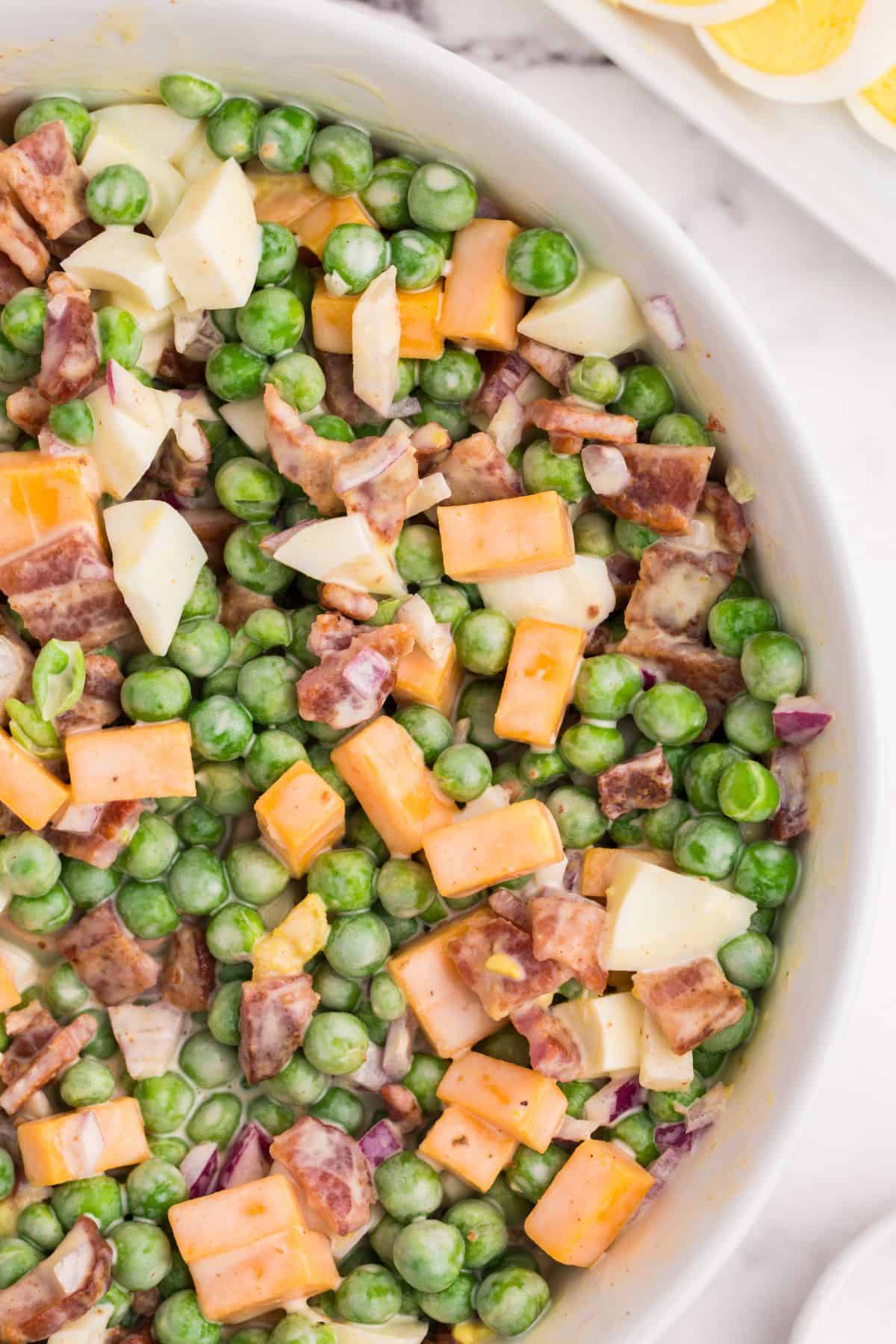 Close up of the old fashioned pea salad recipe in a serving bowl.