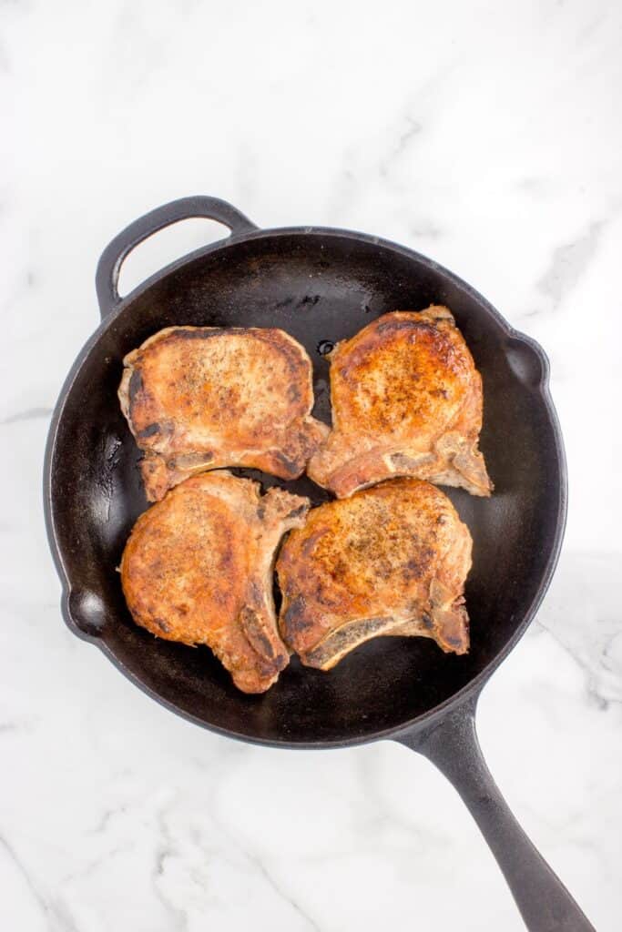 seared pork chops in a cast iron