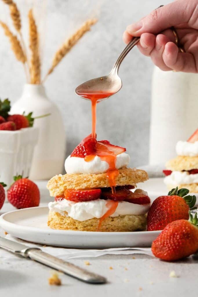 drizzling sugared strawberry juice over shortcakes
