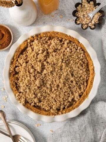 Finished apple pie graham cracker pie crust in the pie pan.