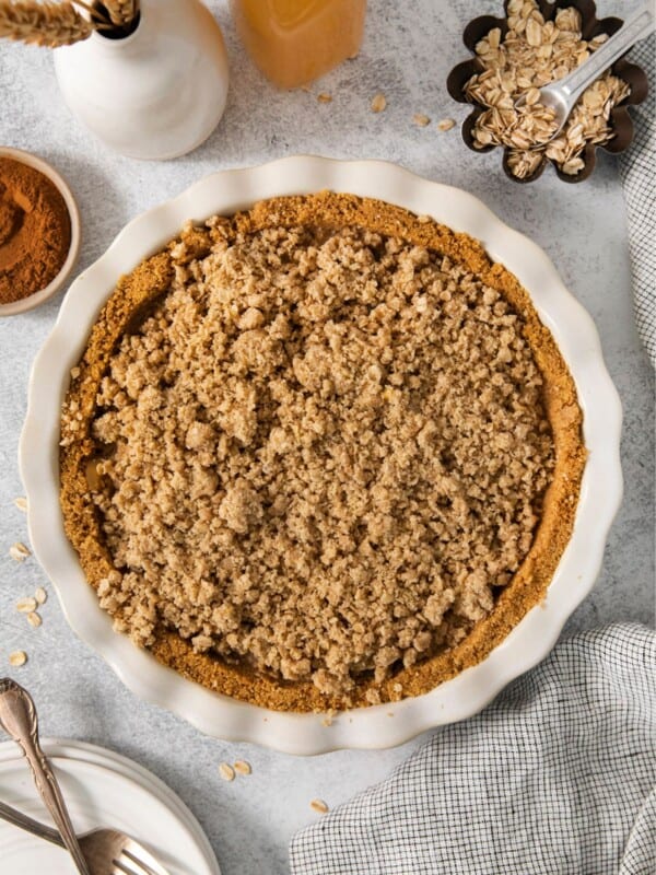 Finished apple pie graham cracker pie crust in the pie pan.
