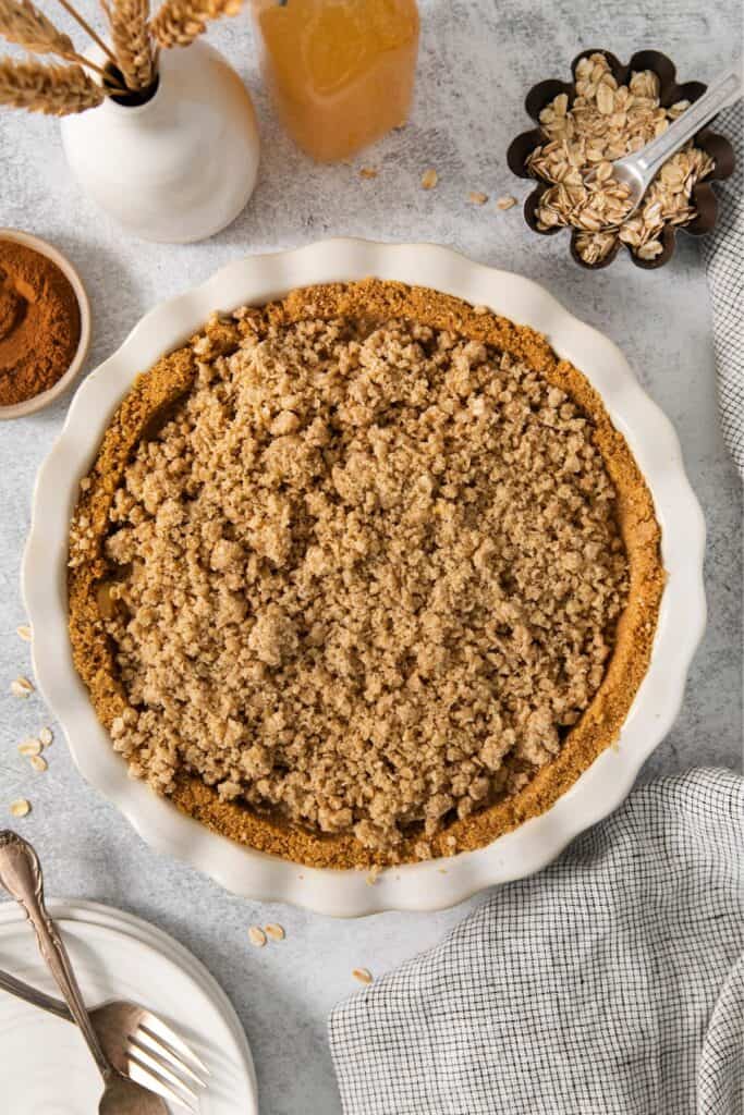 Finished apple pie graham cracker pie crust in the pie pan.