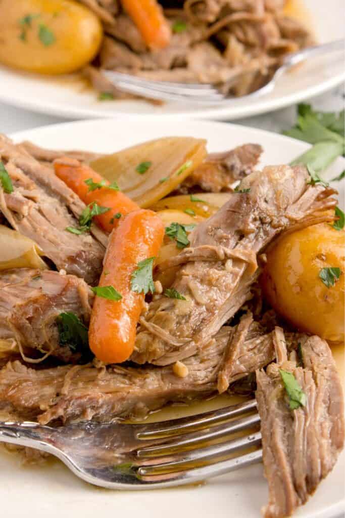 Plated beef sirloin tip roast with carrots and potatoes.