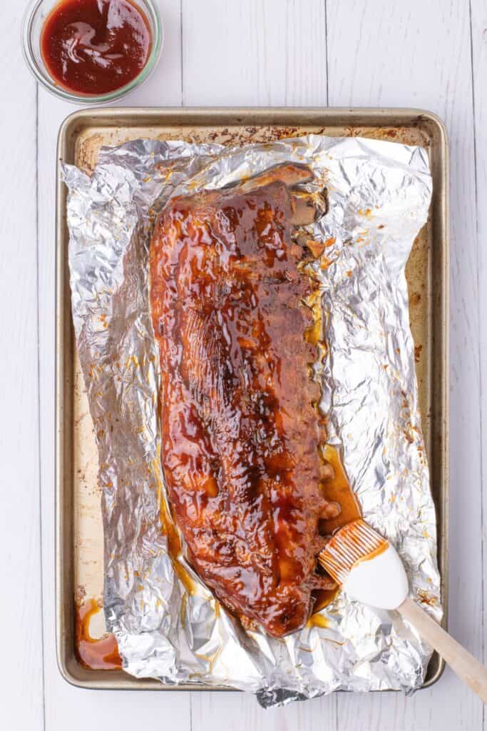 adding bbq sauce to baked pork ribs