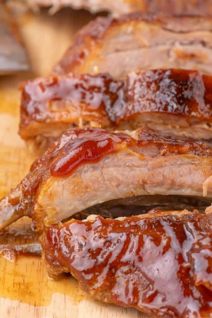 close up of juicy pork baby back ribs with bbq sauce