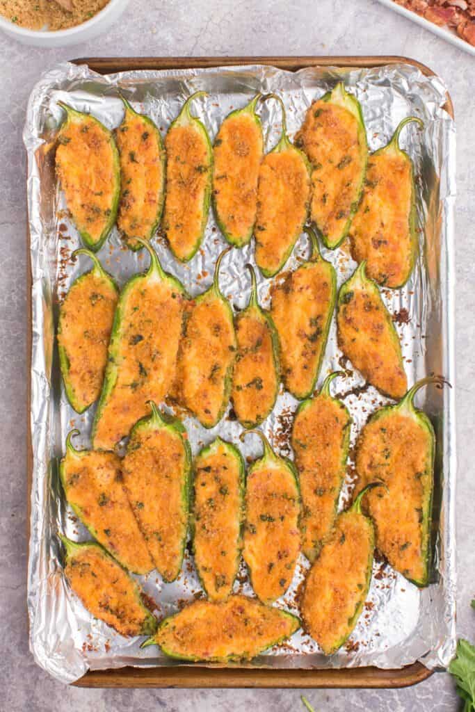 baked jalapeno peppers on a baking sheet 