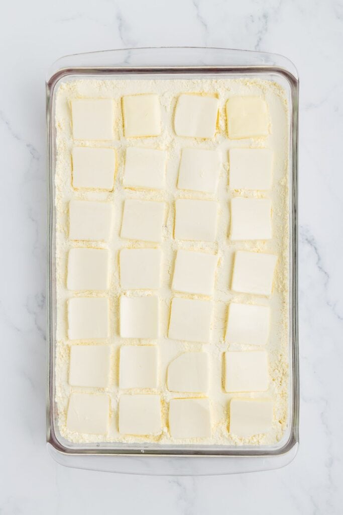 adding sliced butter over cake mix layer 