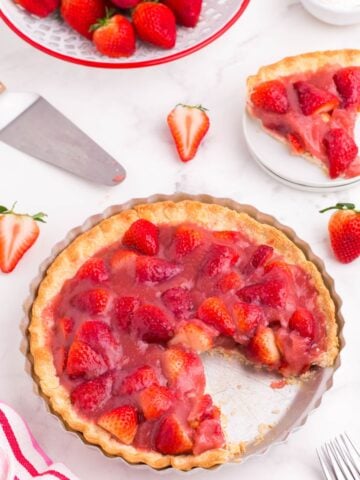 cutting out a slice of sweet strawberry pie