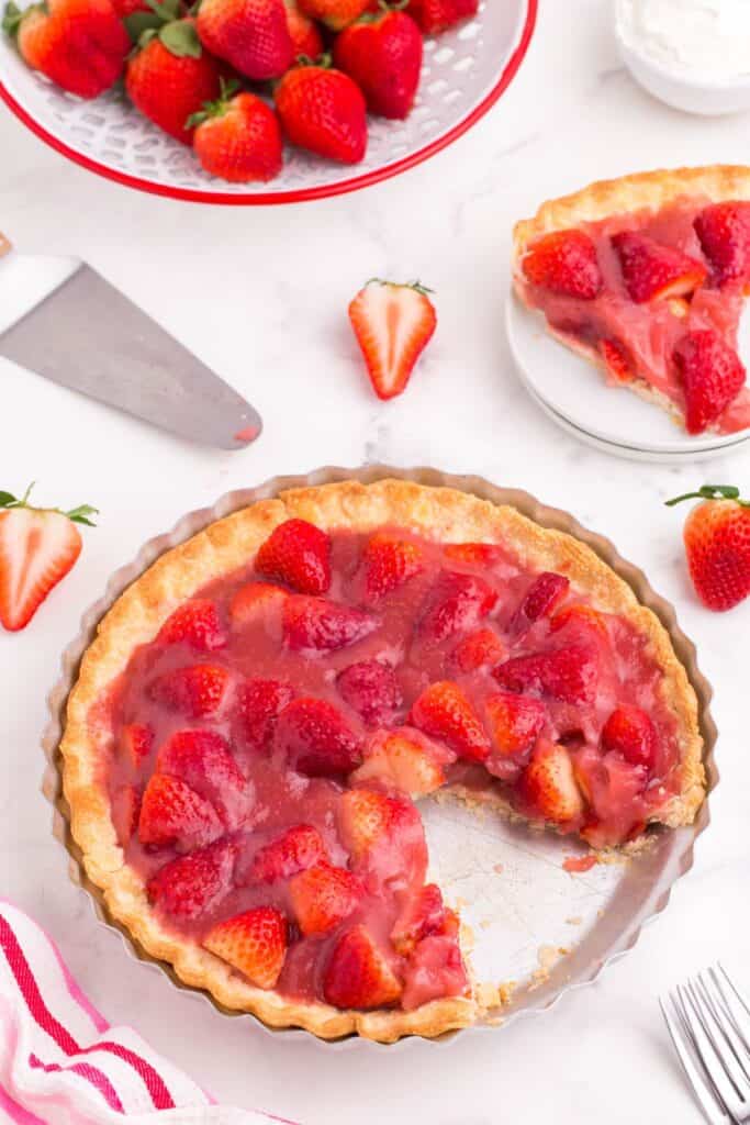 cutting out a slice of sweet strawberry pie 